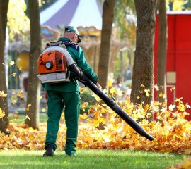 Working,In,The,Park,Removes,Autumn,Leaves,With,A,Blower Working,In,The,Park,Removes,Autumn,Leaves,With,A,Blower